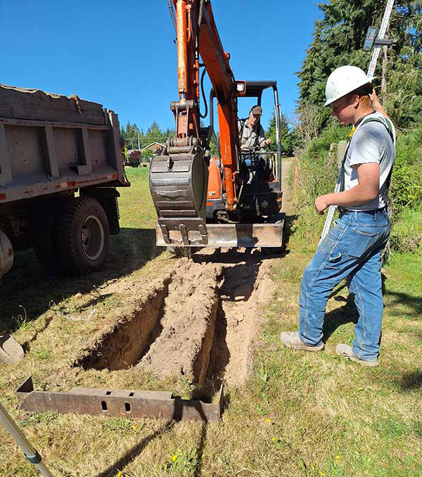 men working digging a foundation for masonry work