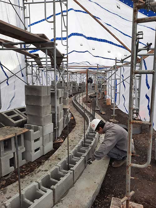masonry brick construction with worker in progress