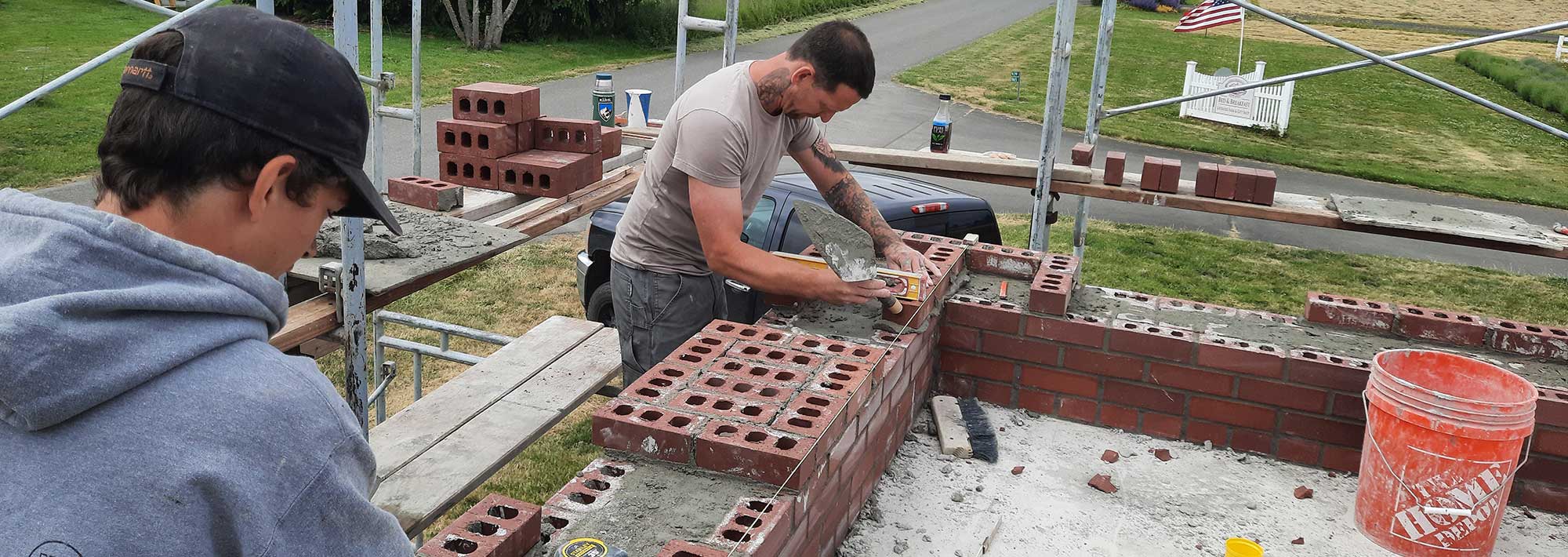 two men working on block wall as Structural Specialists