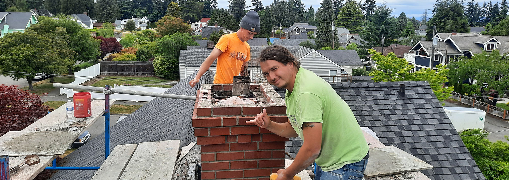 two men working on a chimney