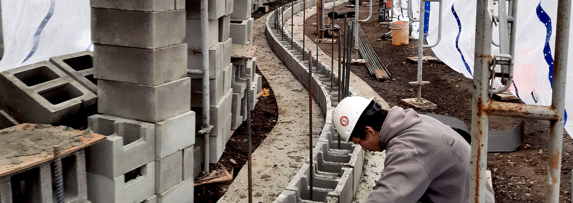 man working on a brick foundation